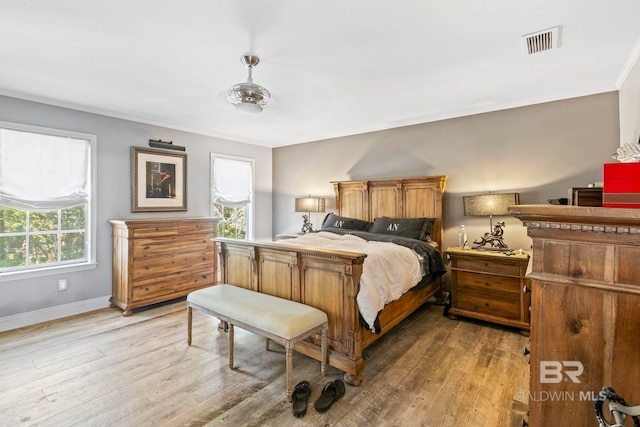 bedroom with ceiling fan and wood-type flooring