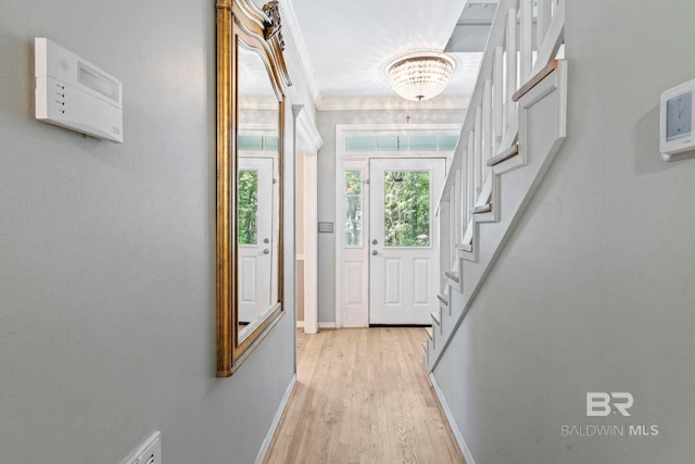 entryway featuring a chandelier and light hardwood / wood-style floors