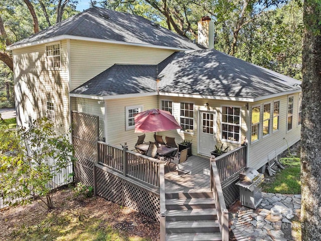 back of house featuring a deck