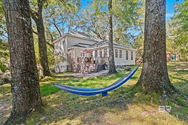 exterior space featuring a yard and a wooden deck