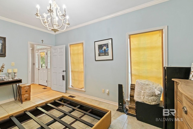 tiled entryway with a chandelier and ornamental molding