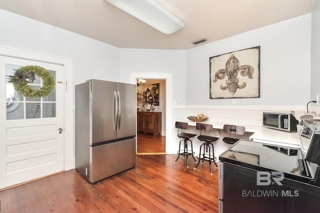 kitchen featuring appliances with stainless steel finishes and hardwood / wood-style floors