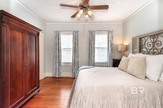 bedroom with crown molding, ceiling fan, and wood-type flooring