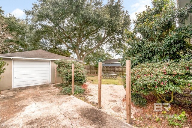view of patio with an outbuilding and a garage