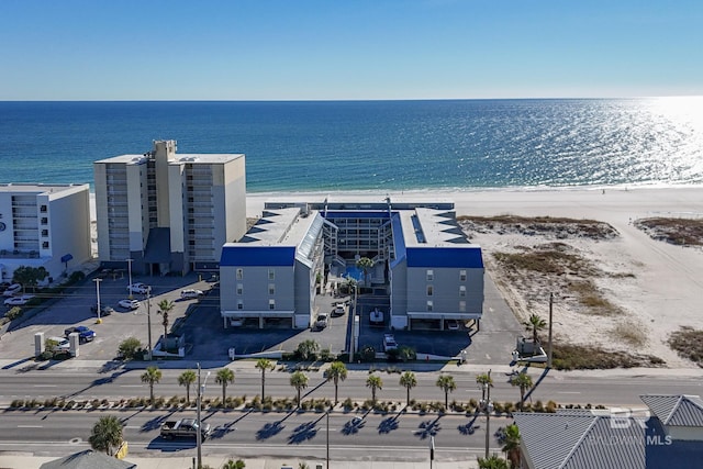 drone / aerial view with a beach view and a water view