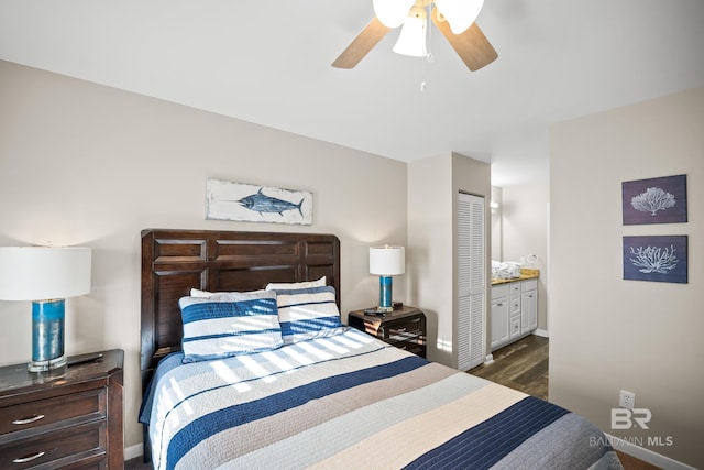 bedroom featuring baseboards, a ceiling fan, ensuite bath, wood finished floors, and a closet