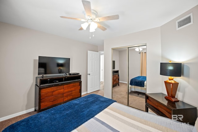 bedroom with light colored carpet, a ceiling fan, baseboards, visible vents, and a closet