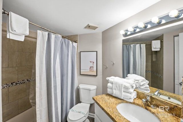 bathroom featuring shower / bath combo, visible vents, vanity, and toilet