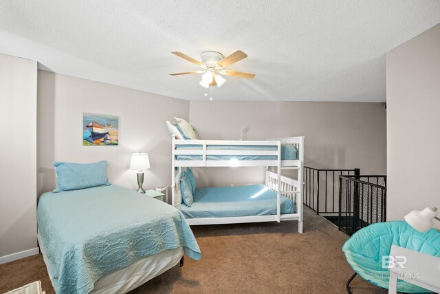 bedroom with carpet floors, ceiling fan, and a textured ceiling