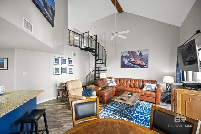 living area featuring visible vents, stairway, dark wood-type flooring, high vaulted ceiling, and beamed ceiling