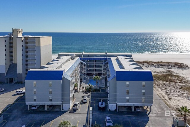 birds eye view of property with a view of the beach and a water view