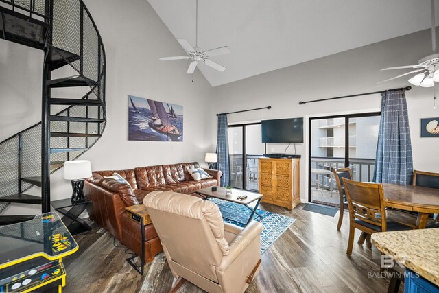 living area with high vaulted ceiling, a ceiling fan, and wood finished floors