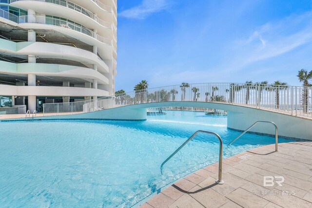 view of swimming pool featuring a water view