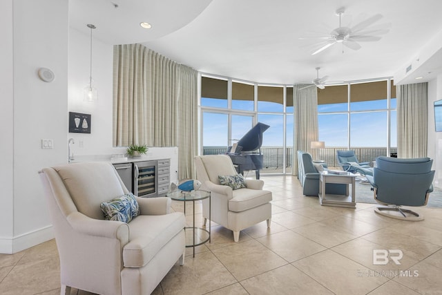 tiled living room featuring expansive windows, wine cooler, and ceiling fan