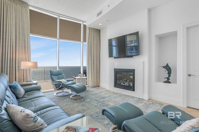 26302 Perdido Beach Blvd Unit D2301, Orange Beach, AL 36561 - living area featuring visible vents, a glass covered fireplace, baseboards, and floor to ceiling windows