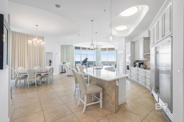 26302 Perdido Beach Blvd Unit D2301, Orange Beach, AL 36561 - kitchen featuring oven, an inviting chandelier, light countertops, light tile patterned flooring, and stainless steel built in refrigerator