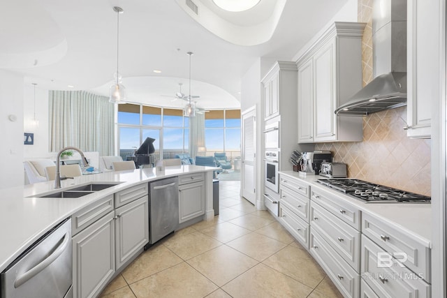 26302 Perdido Beach Blvd Unit D2301, Orange Beach, AL 36561 - kitchen with wall chimney exhaust hood, open floor plan, a sink, and appliances with stainless steel finishes