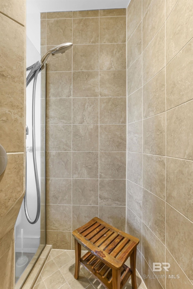 bathroom featuring a tile shower and tile patterned floors