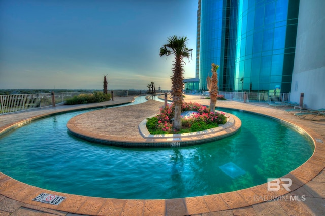 view of pool at dusk