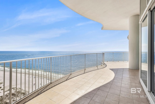 balcony featuring a water view and a view of the beach