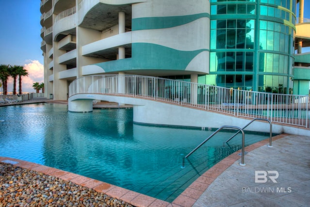 view of pool at dusk