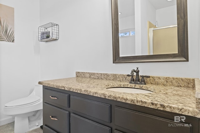 bathroom featuring tile patterned flooring, vanity, toilet, and a shower with shower door