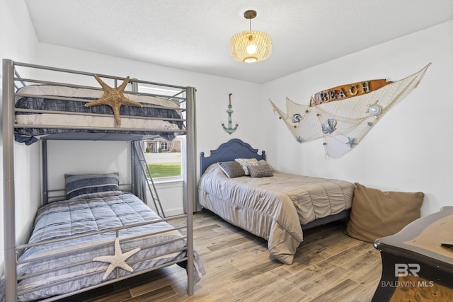 bedroom featuring hardwood / wood-style floors and a textured ceiling