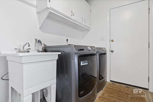 laundry area with cabinets and separate washer and dryer