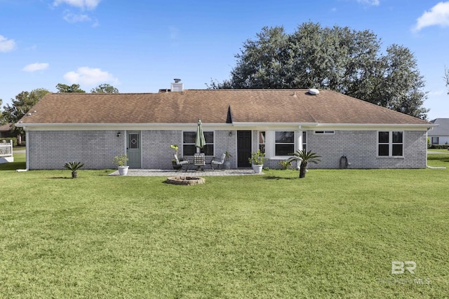 back of property featuring a yard and a patio