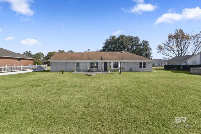 back of house with a lawn and a patio area