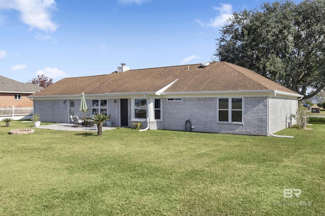 rear view of property with a patio area and a yard