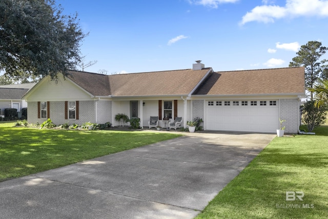 ranch-style home featuring a front lawn and a garage