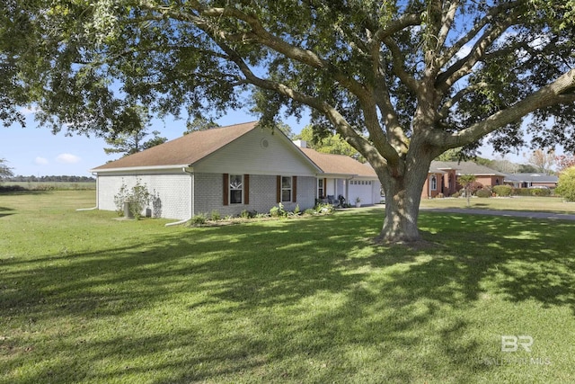 ranch-style home featuring a garage and a front yard