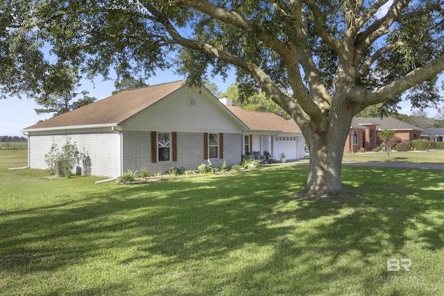 ranch-style house featuring a front yard and a garage