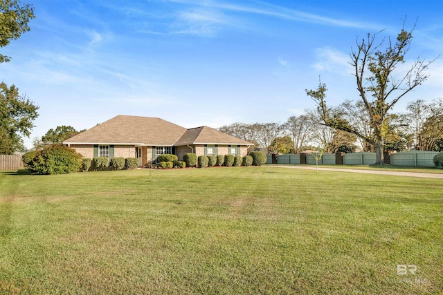 ranch-style home with a front yard