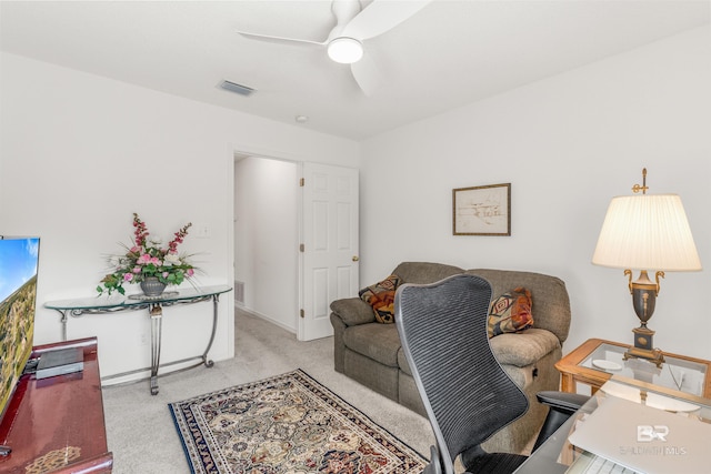 carpeted living room featuring ceiling fan