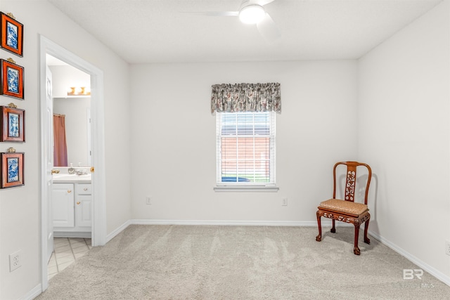 living area with light colored carpet and ceiling fan