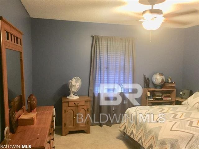 carpeted bedroom featuring ceiling fan