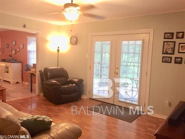 living room with wood-type flooring, ceiling fan, and french doors