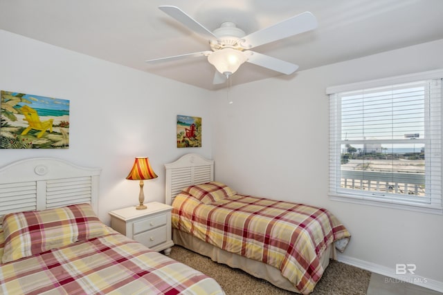 carpeted bedroom featuring baseboards and ceiling fan