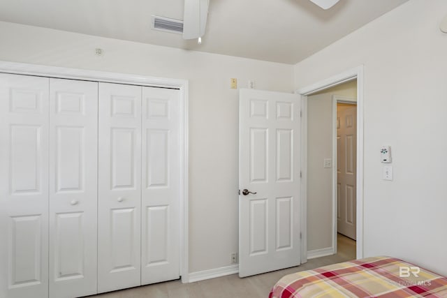 bedroom with a closet, a ceiling fan, baseboards, and visible vents