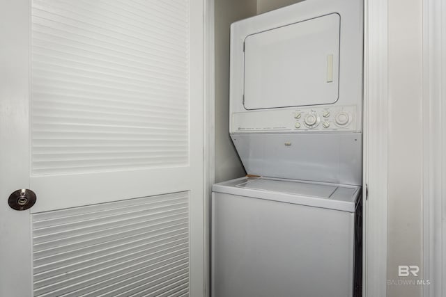 laundry area with stacked washer / drying machine and laundry area