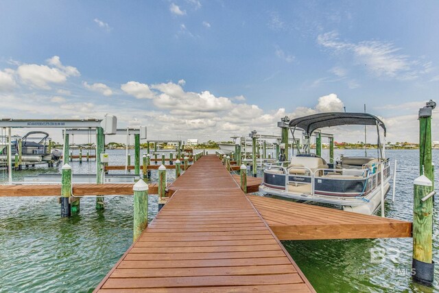 dock area featuring boat lift and a water view