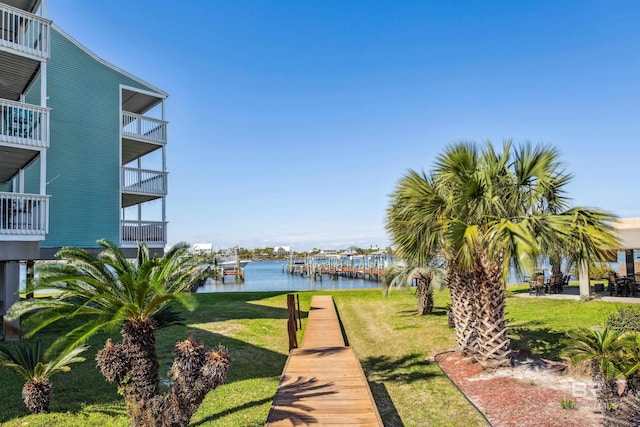 view of home's community featuring a lawn and a water view