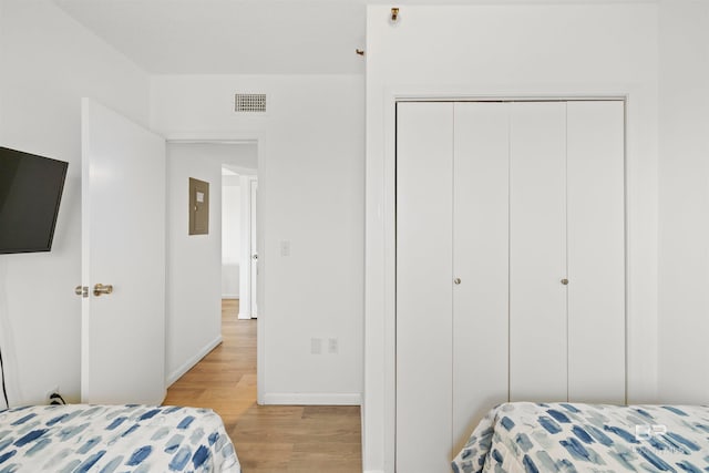 bedroom featuring a closet and light wood-type flooring