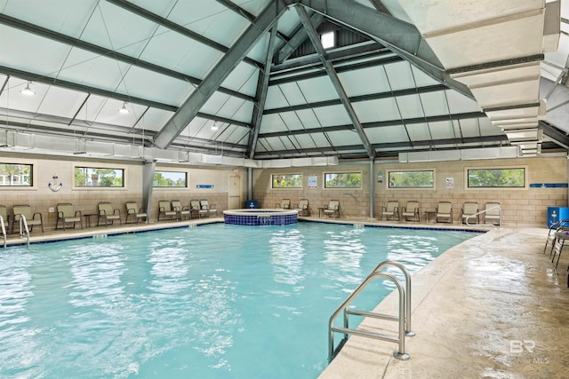 view of swimming pool featuring an indoor hot tub