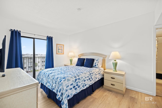 bedroom featuring access to outside and light hardwood / wood-style floors