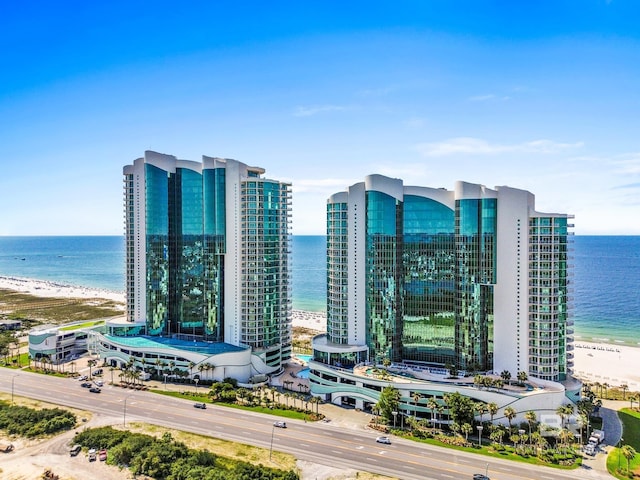 bird's eye view featuring a water view and a beach view