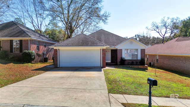 ranch-style home featuring a garage, a front yard, and central air condition unit