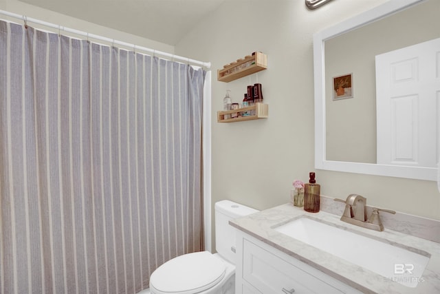 bathroom featuring vanity, curtained shower, and toilet